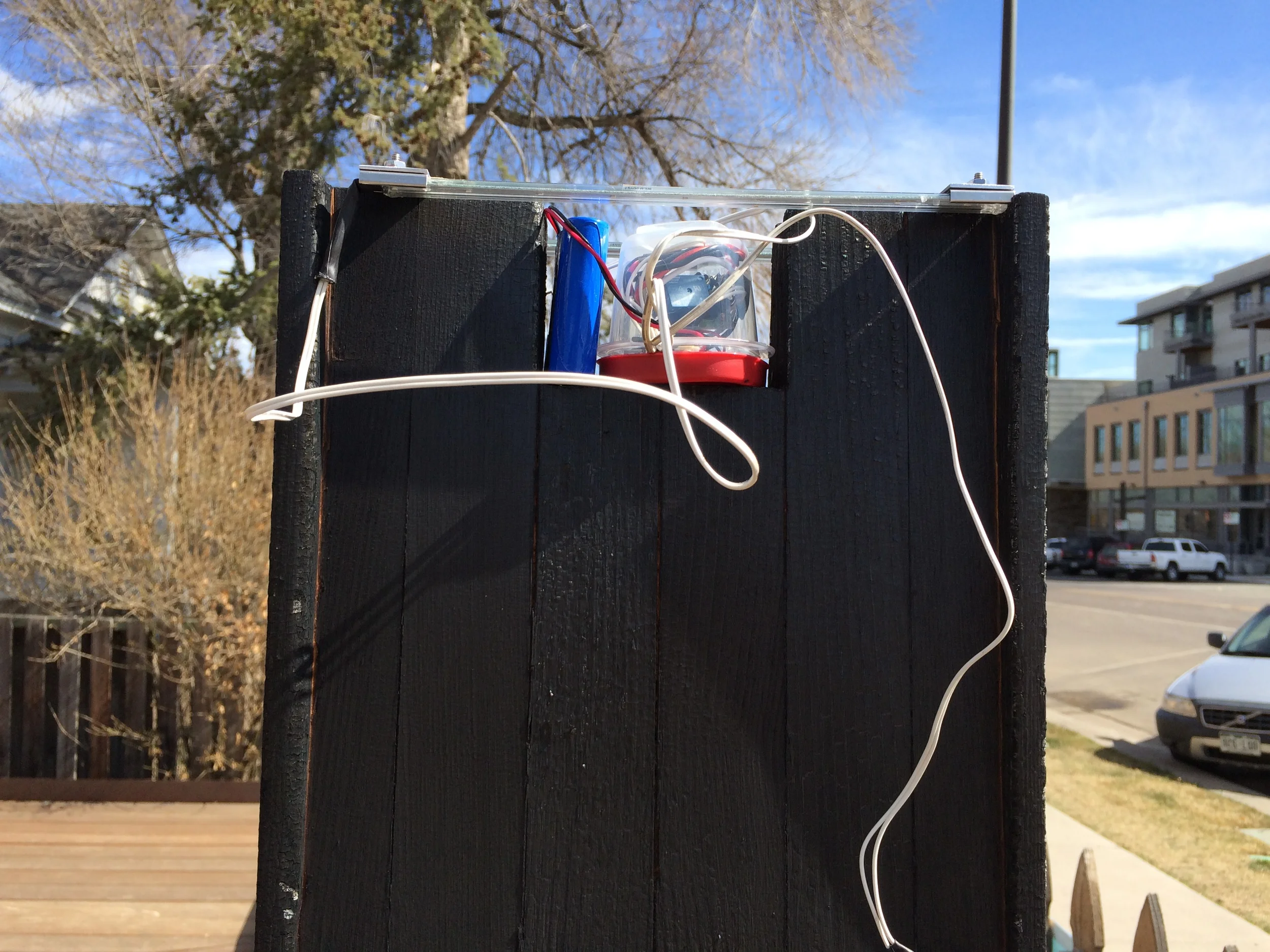  Electronics fitted into place. We also had a piece of galvanized steel flashing to cover the electronics assembly, and actually ended up removing the red tupperware lid in order to fit the flashing and sealant securely into place.&nbsp; 