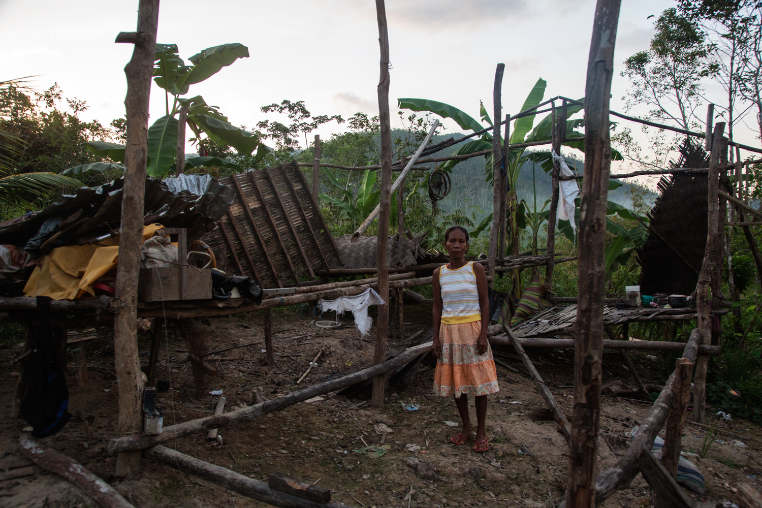  A migrant from Culio living on Busuanga Island in Northern Palawan stands in front of her house that was destroyed by Typhoon Haiyan.&nbsp; 