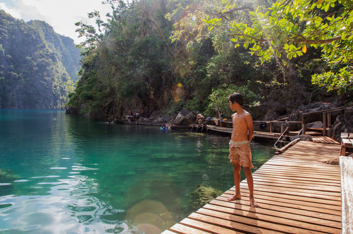  A young Tagnbanua boy looks out at Kayangan Lake on Coron Island, a popular tourist destination in Northern Palawan. The Tagbanua have ancestral domain rights on Coron and surrounding waters but they are at risk of development and pressure from the 