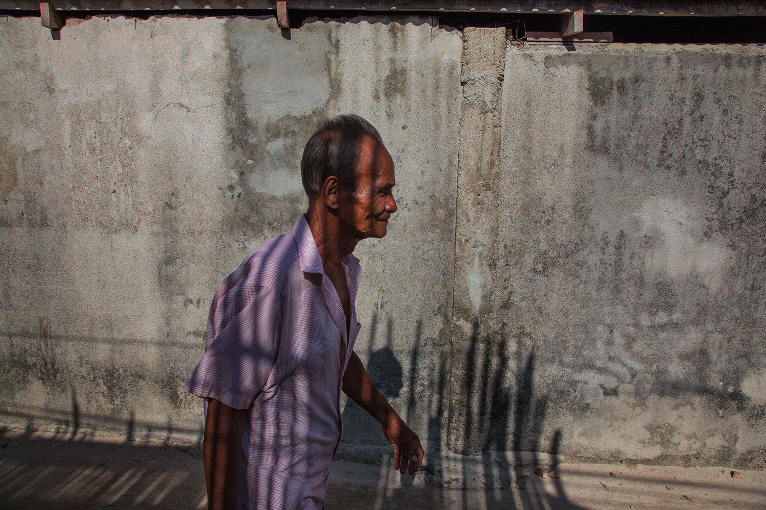  A Tagbanua elder walks home after meeting with aid groups and the Coron Island committee helping to distribute aid to indigenous communities cut off from help after Typhoon Haiyan in the Philippines. 