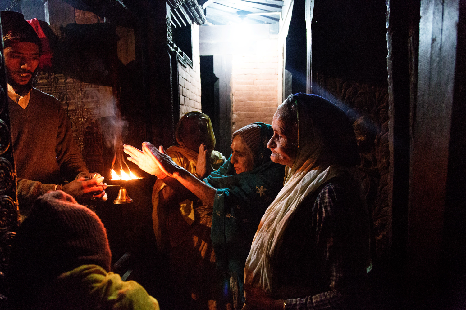  During evening Aarti after a period of prayer ceremonial fire is passed around to allow devotees to raise downturned hands to the flames to receive the flame's power, which they then press to their eyes and head, a purification and a blessing. 