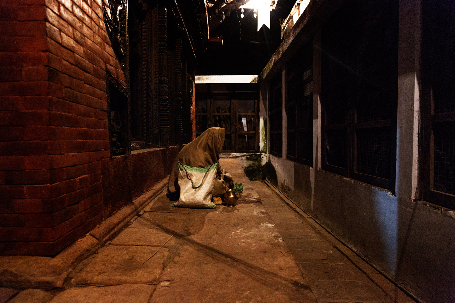  A woman silently prays while she waits for evening Aarti to begin. 