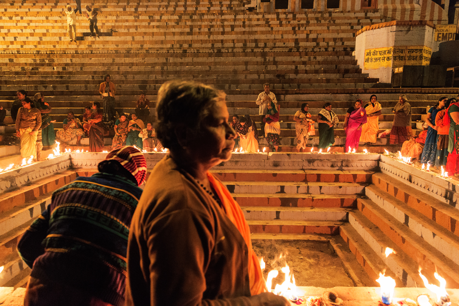  Women gather for evening prayer on a popular Varanasi Ghat by the River Ganga, in Uttar Pradesh India.       