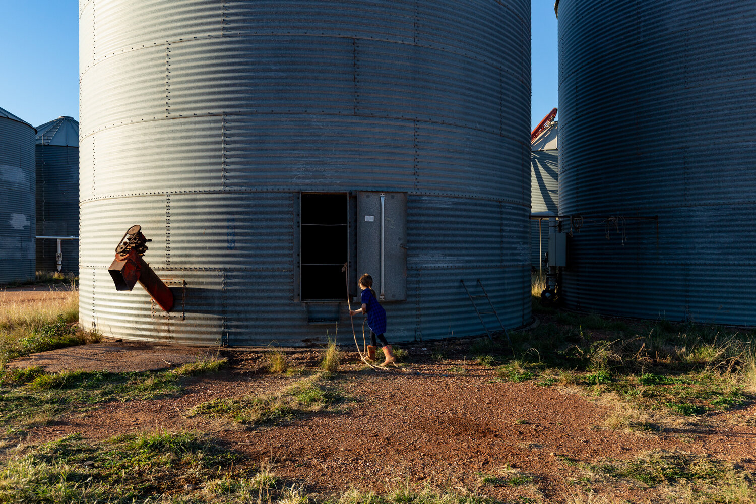  Annalise Klante playing near an empty grain silo on the Klante farm. 