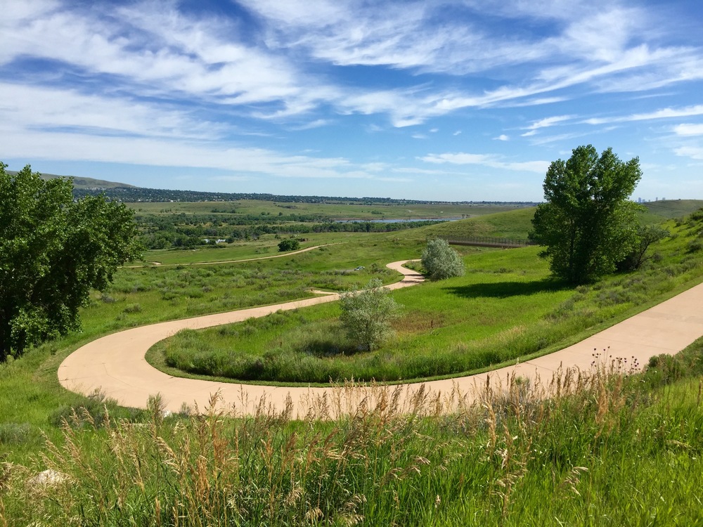  The trail winds up and out of Bear Creek Lake Park before connecting to the C-470 trail. The view takes in Bear Creek Lake Park and Green Mountain in the distance 