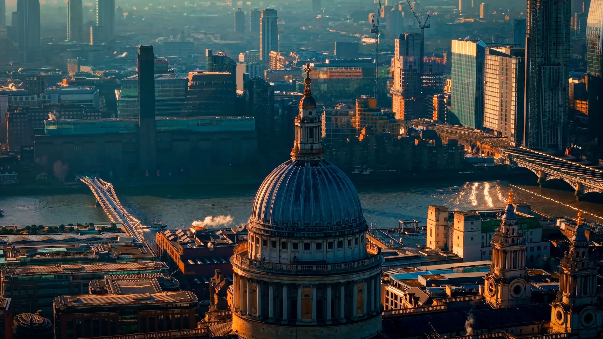 A sweeping cinematic drone shot of St Paul's Cathedral in the City of London financial district, showcasing the scale and authority required for global brand storytelling.