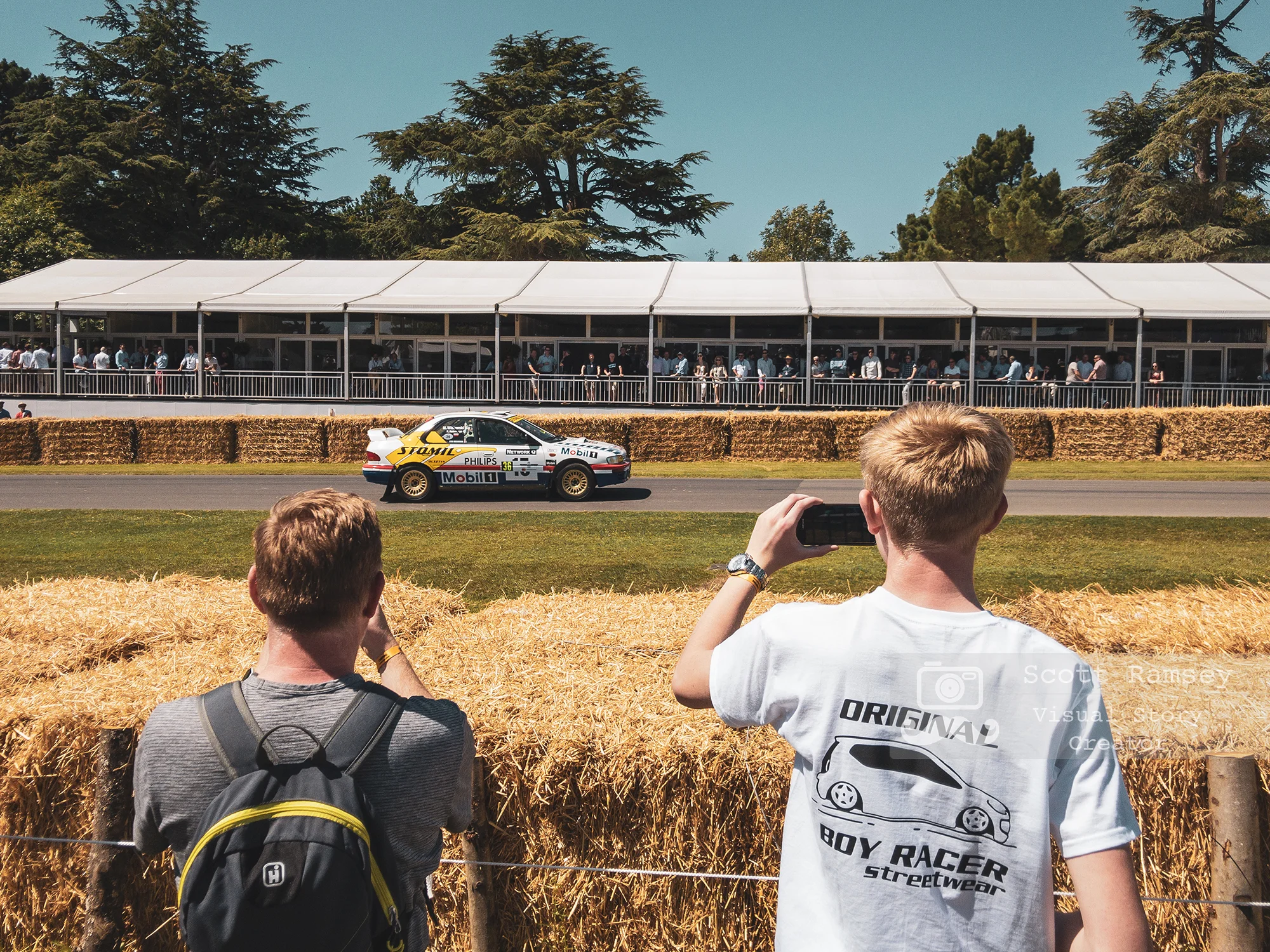 UK Professional iPhone Photographer Scott Ramsey Documents The Goodwood Festival Of Speed. In Photo - Boy Racer’s photograph a car at the event in Chichester, West Sussex. © Scott Ramsey - Photographer & Visual Content Creator.