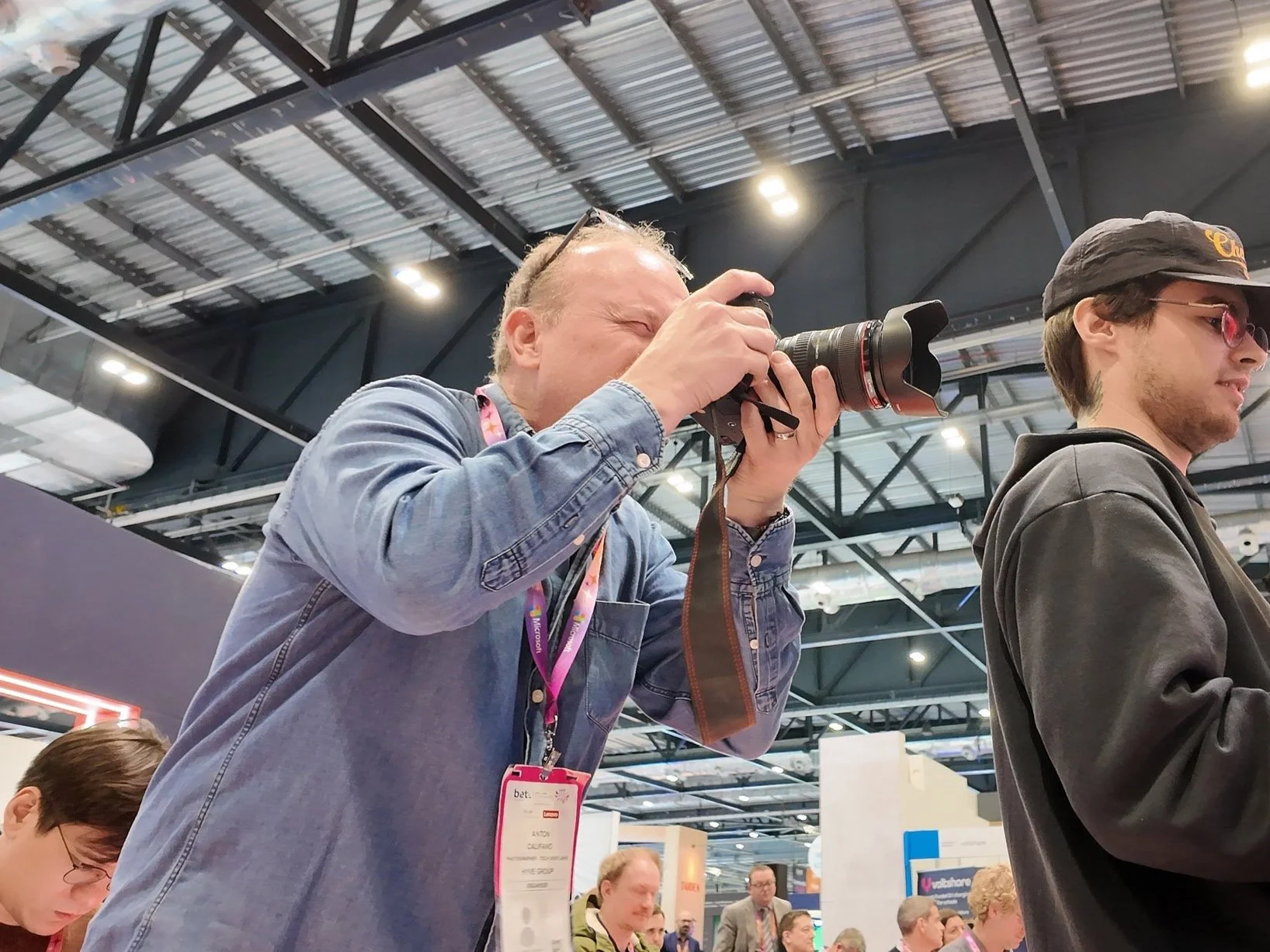 A member of the Scott Ramsey videography team filming high-impact brand content at a trade show in ExCeL London.