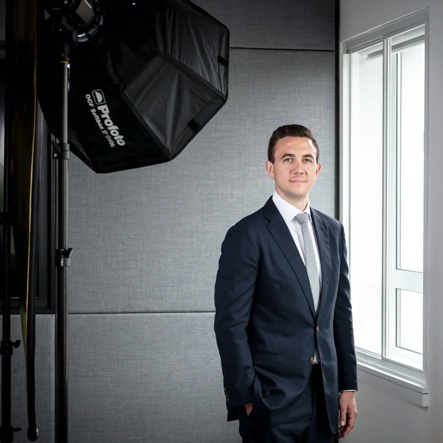 A broadcast-quality corporate videography session featuring an executive in a London office next to a professional studio light, capturing leadership insights through a high-end directorial approach.