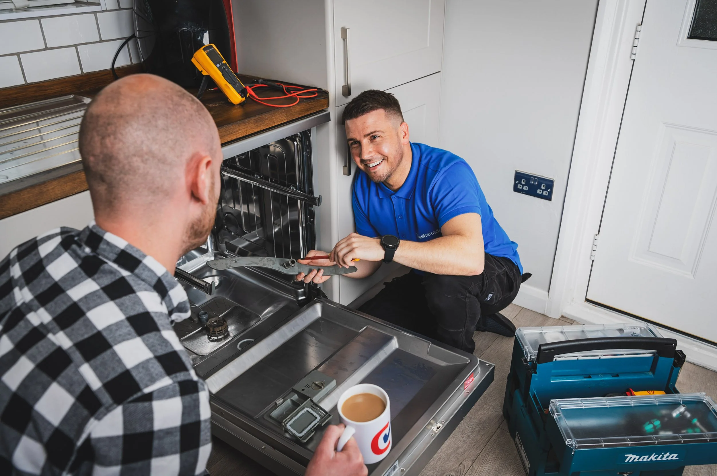 London commercial photographer Scott Ramsey: An authentic lifestyle shot of a Checkatrade engineer interacting with a customer for a national advertising campaign, demonstrating directorial brand storytelling.