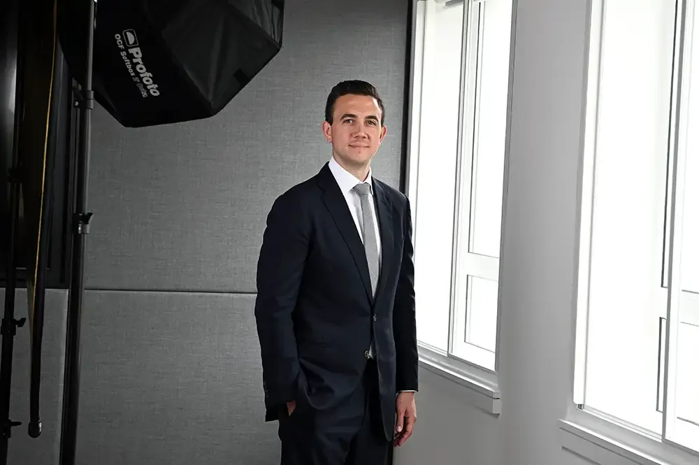 A broadcast-quality corporate videography session featuring an executive in a London office next to a professional studio light, capturing leadership insights through a high-end directorial approach.