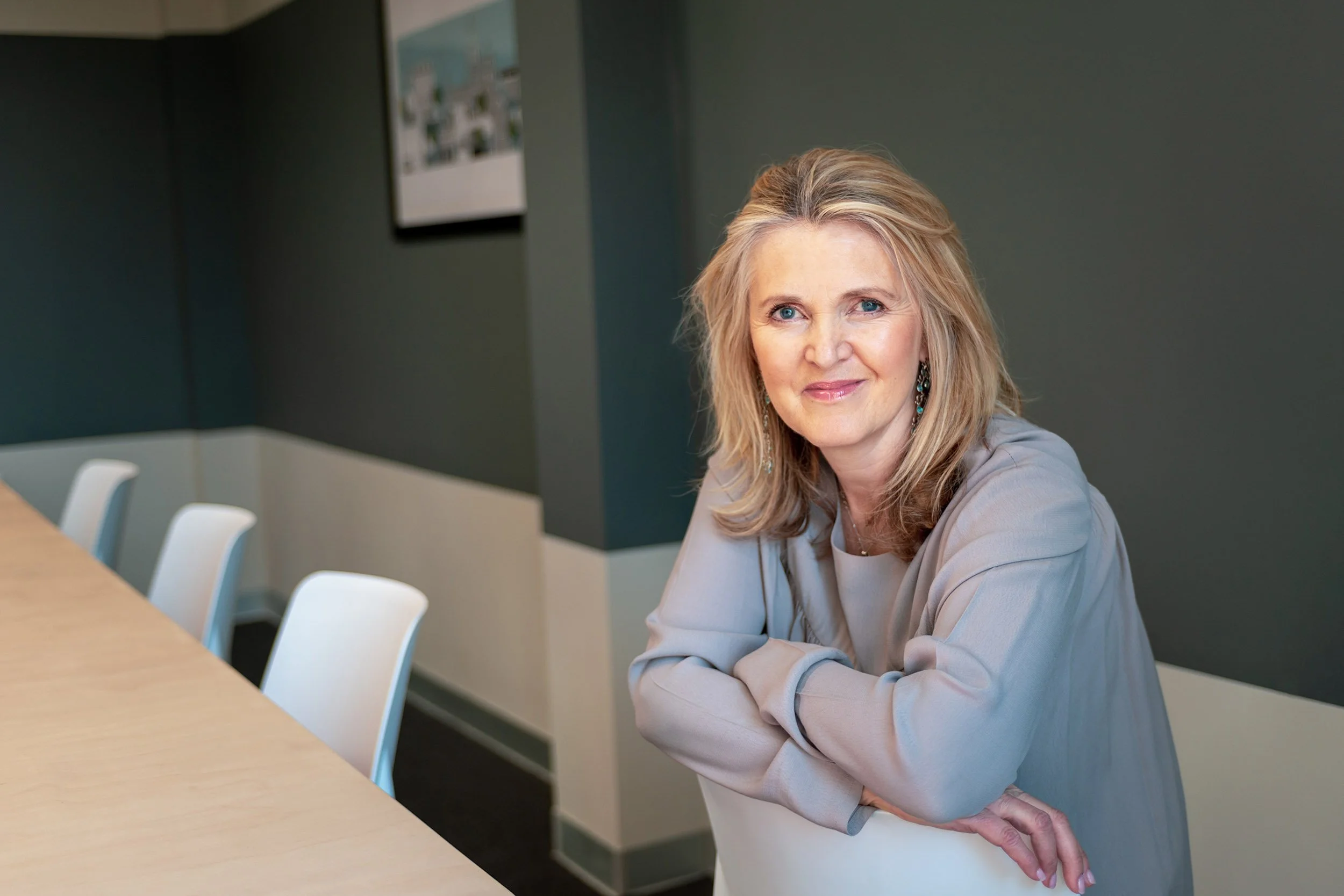 A professional commercial portrait of a corporate executive in a modern Chichester office. This image represents the high-end executive photography services delivered across West Sussex by our regional Brighton Bureau.