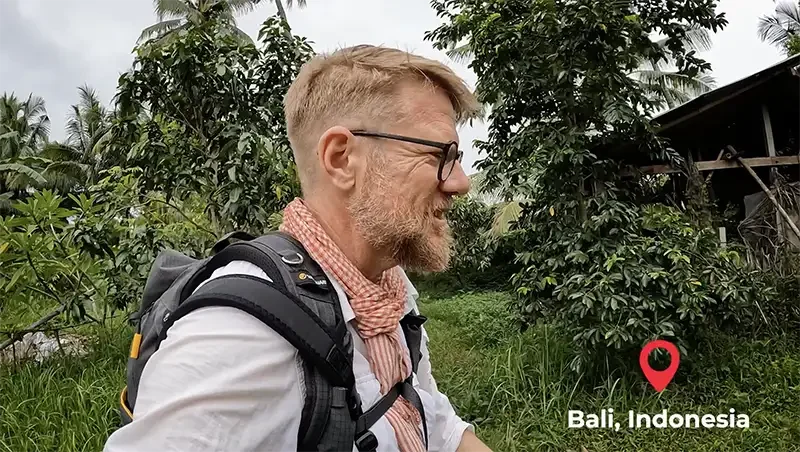 Documentary filmmaker Scott Ramsey on location in a bali jungle, Indonesia.