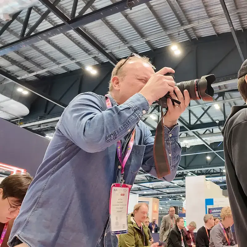 A member of the Scott Ramsey videography team filming high-impact brand content at a trade show in ExCeL London.