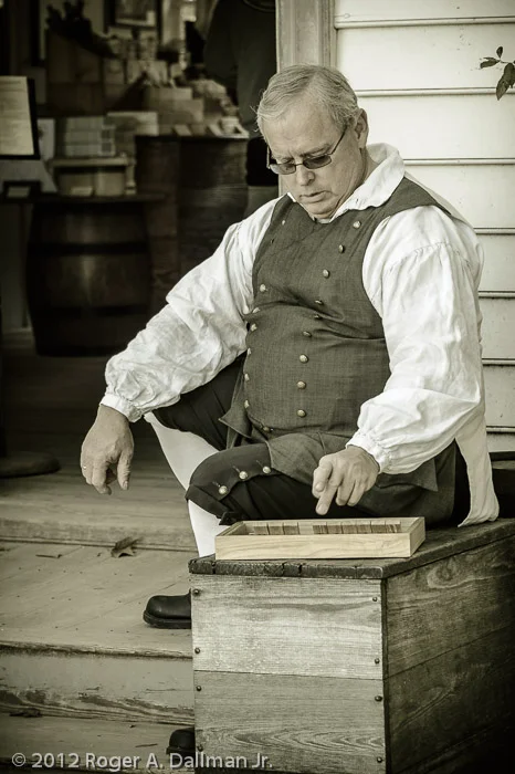 The storekeeper takes a break in Colonial Williamsburg.