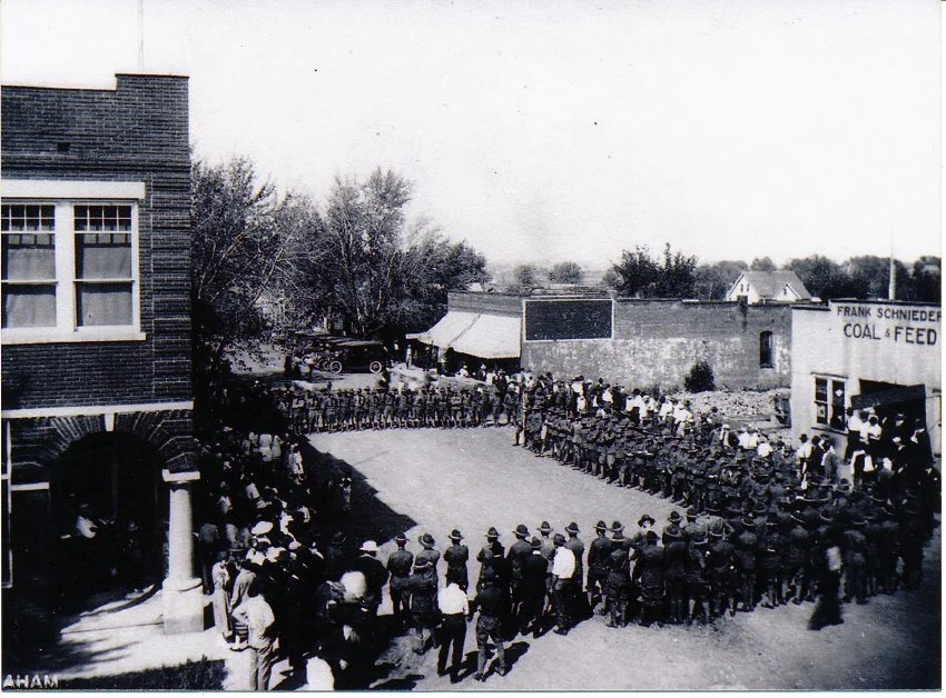 View of downtown Buckner, Missouri with WWI soldiers in formation, circa 1917-1919