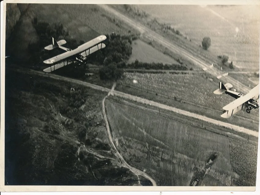 Bi-wing airplanes fly over Raytown