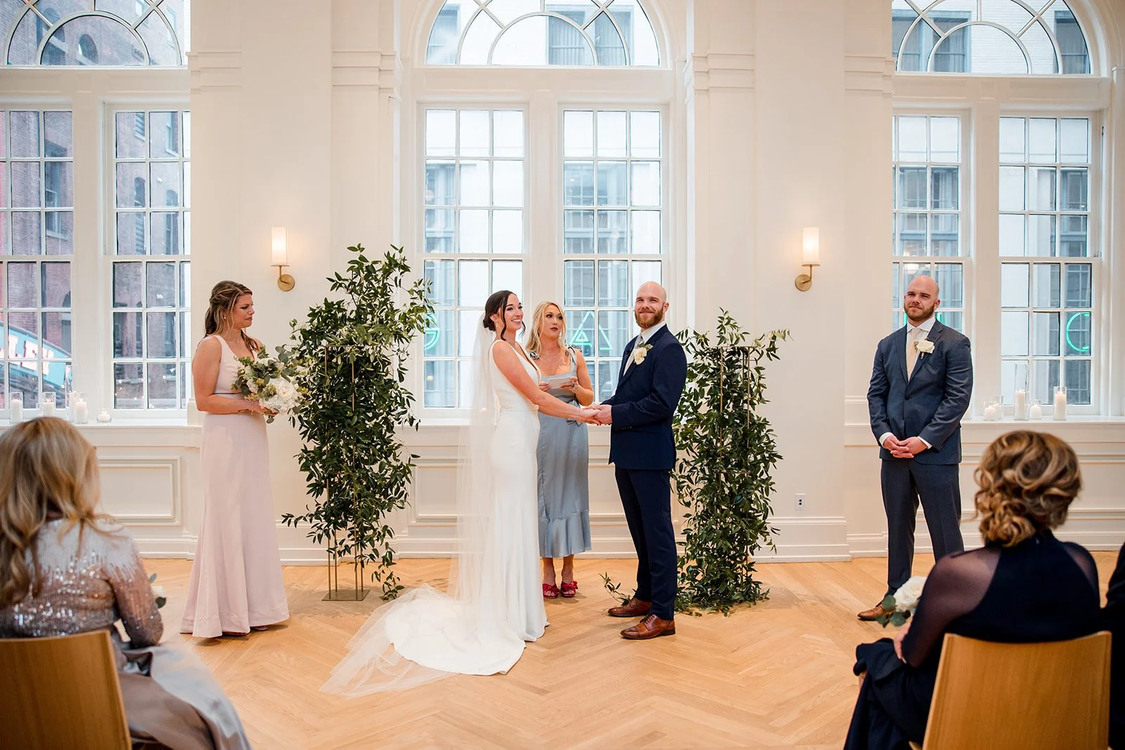 bridal-couple-smiling-at-guests.jpg