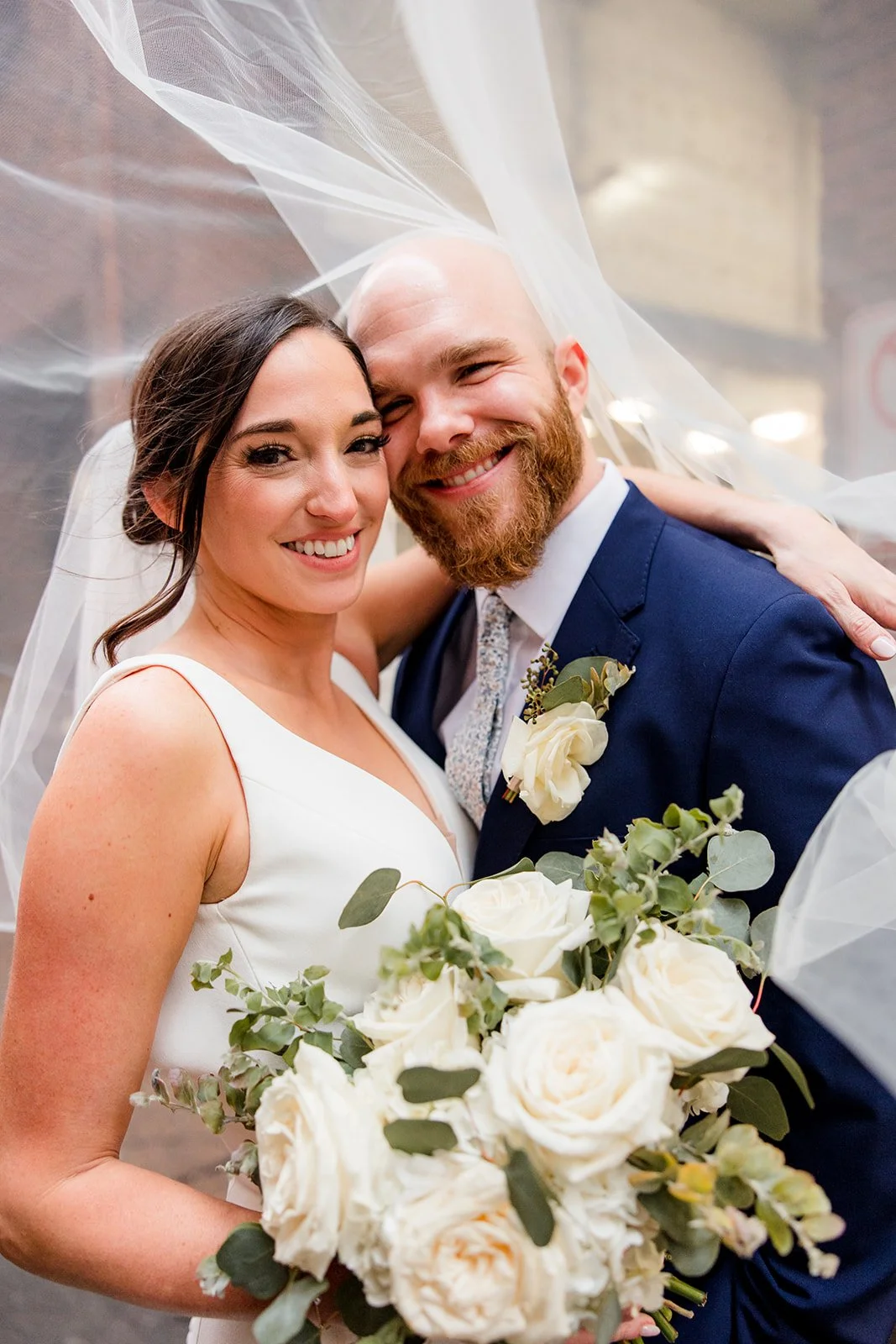 bride-and-groom-smiling-under-veil.jpg