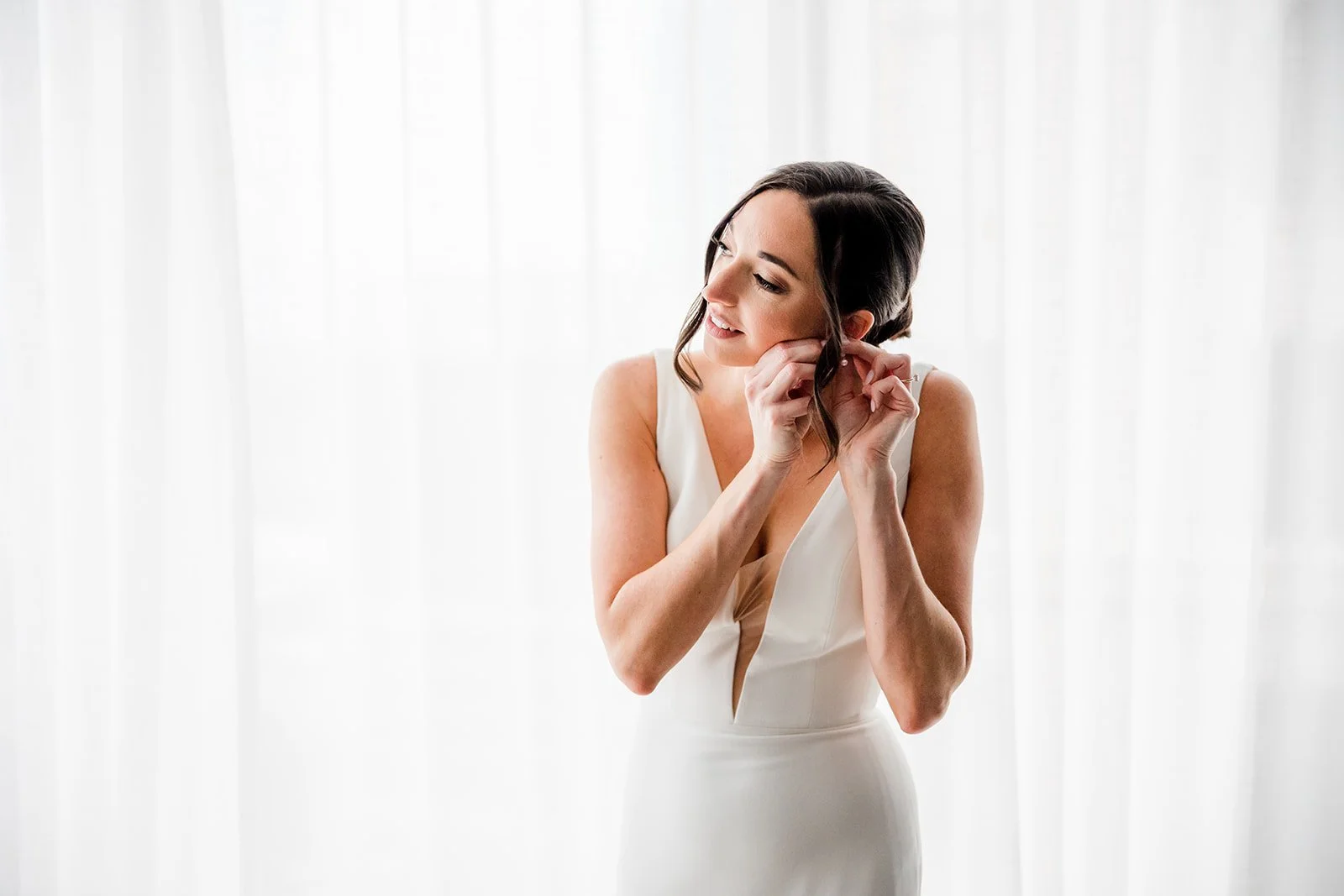 bride-putting-earrings-in.jpg