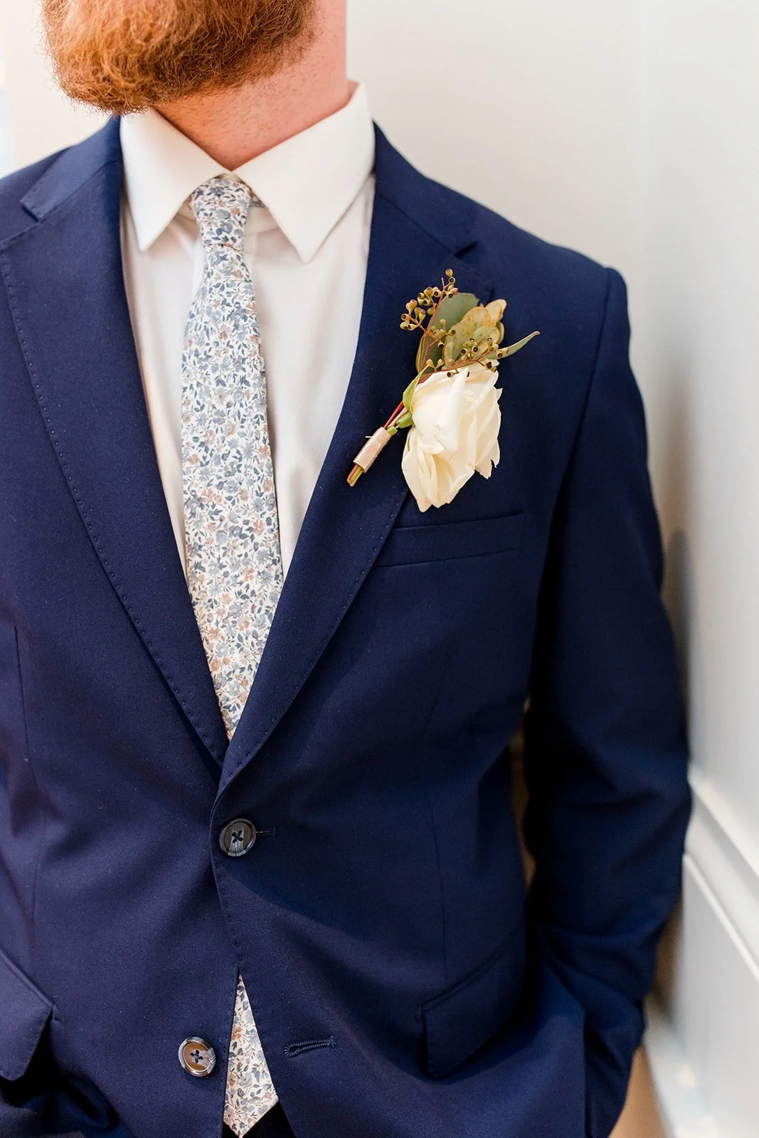groom-wearing-white-rose-boutonniere.jpg