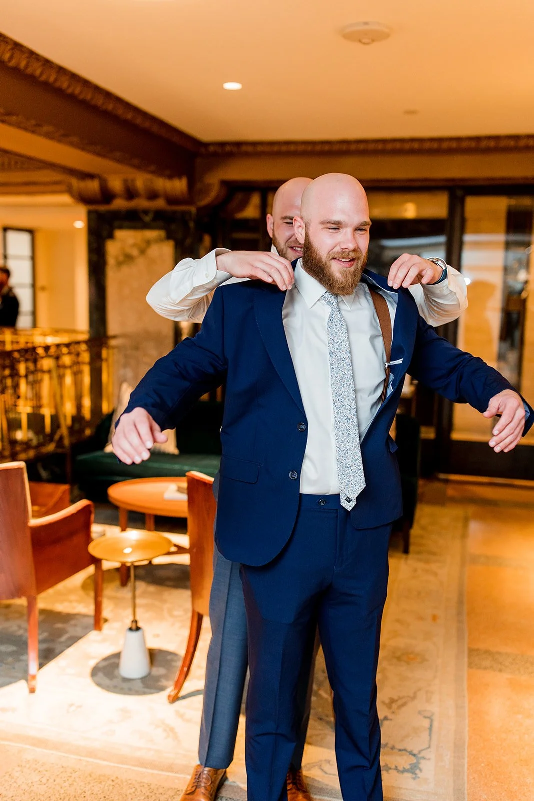 groomsman-helping-groom-with-jacket.jpg