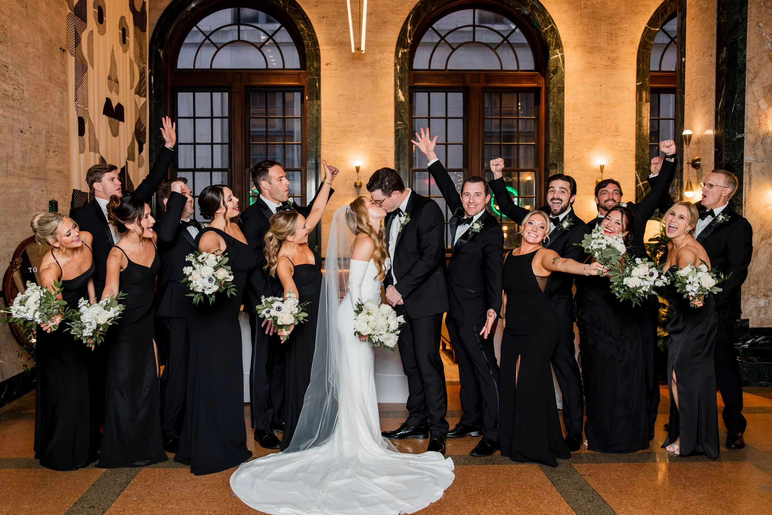 bride-groom-kiss-bridal-party-cheering.jpg