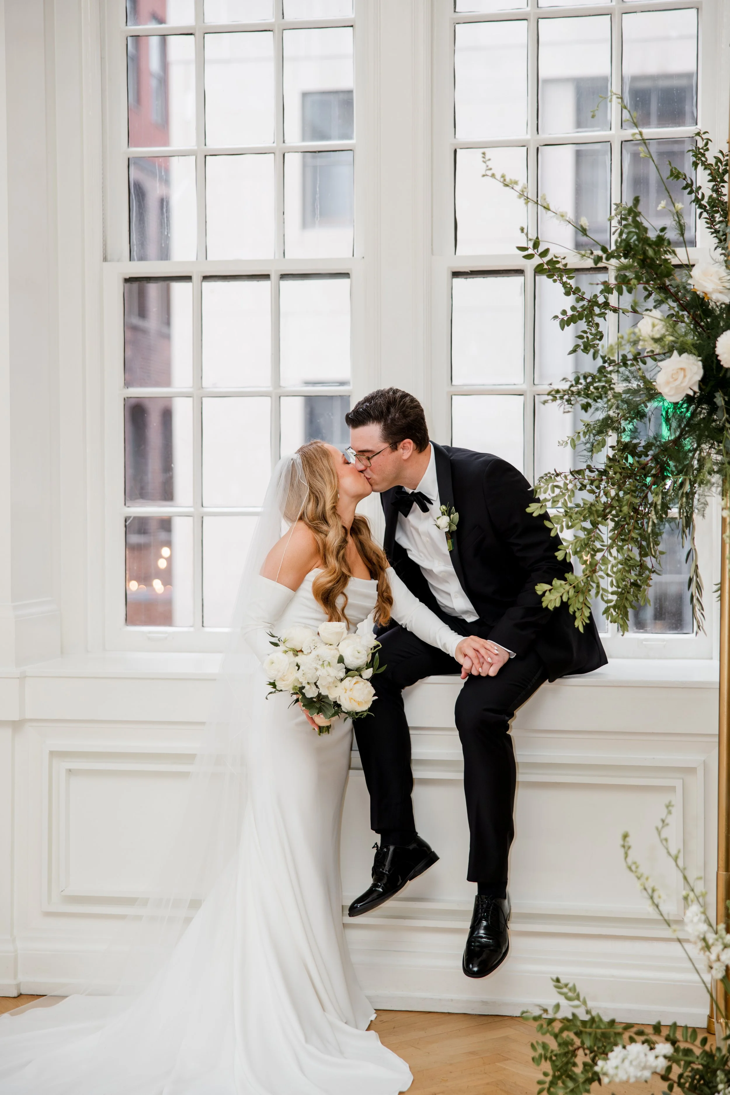 bride-groom-kissing-in-window-seat.jpg