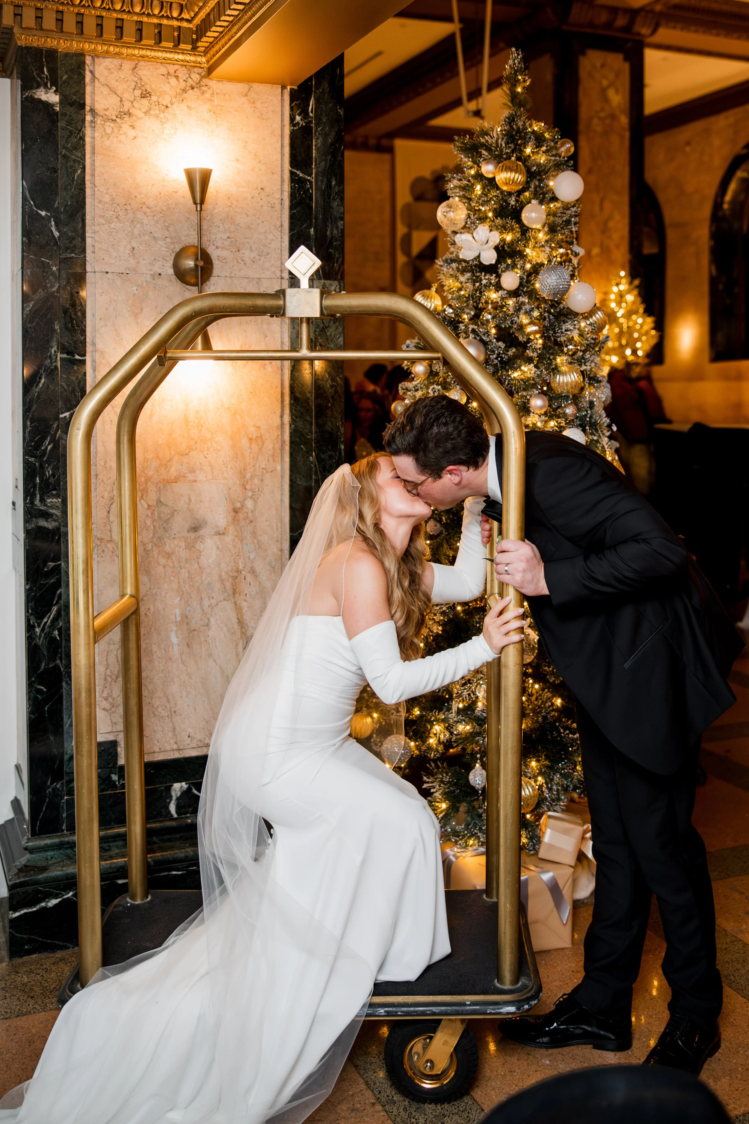 bride-groom-kissing-on-luggage-cart.jpg