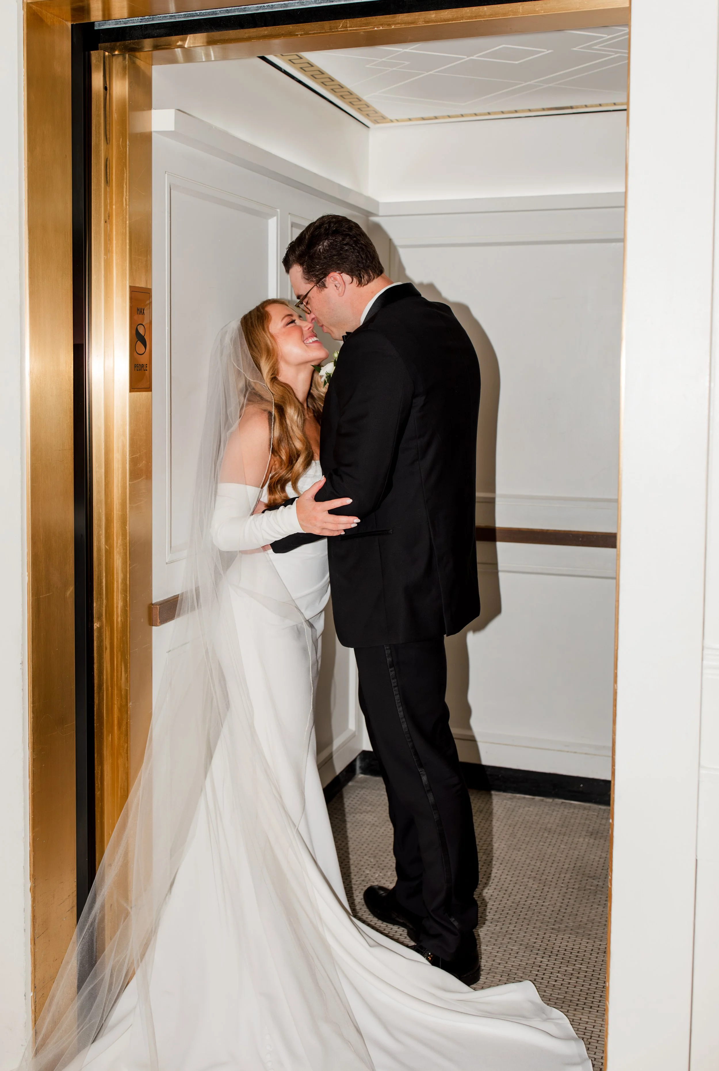 bride-groom-smiling-in-elevator.jpg