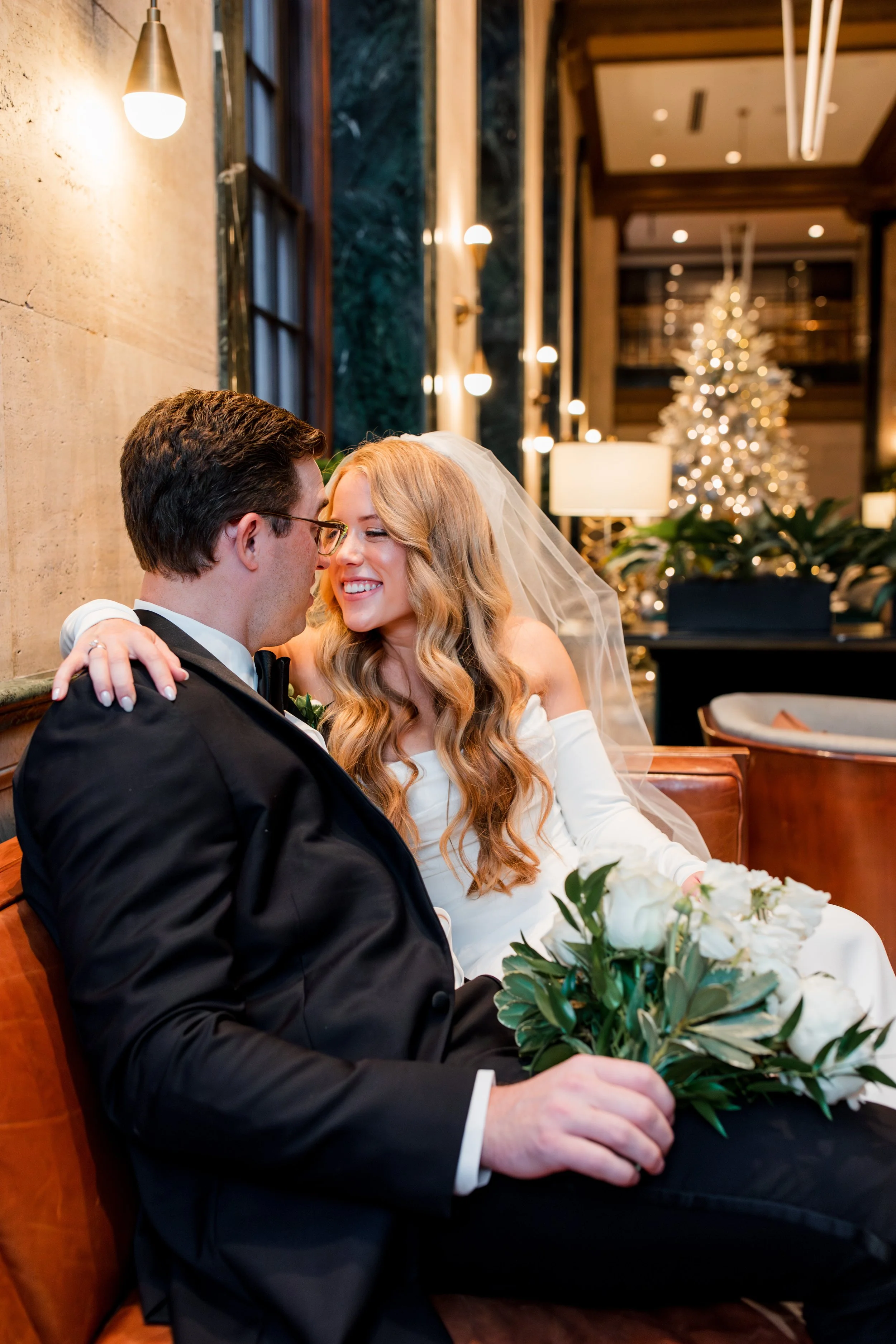 bride-groom-sitting-on-leather-couch.jpg