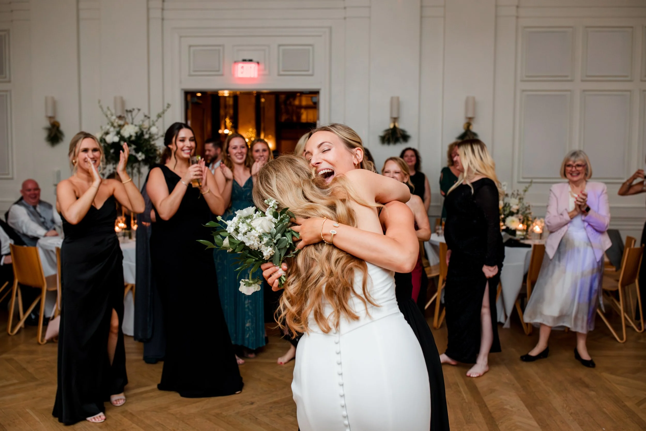 bride-hugging-girl-with-toss-bouquet.jpg