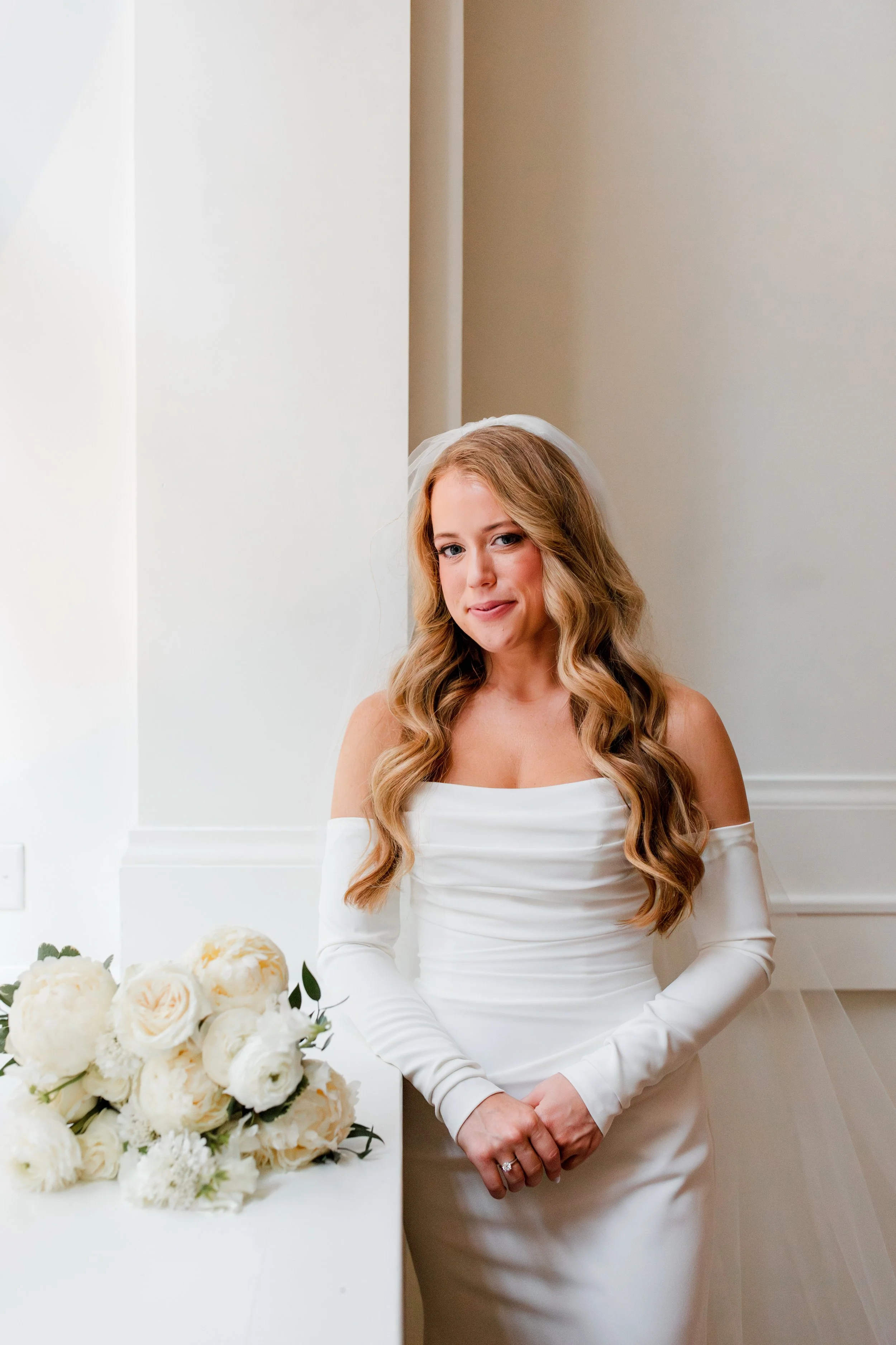 bride-standing-by-window-smiling.jpg