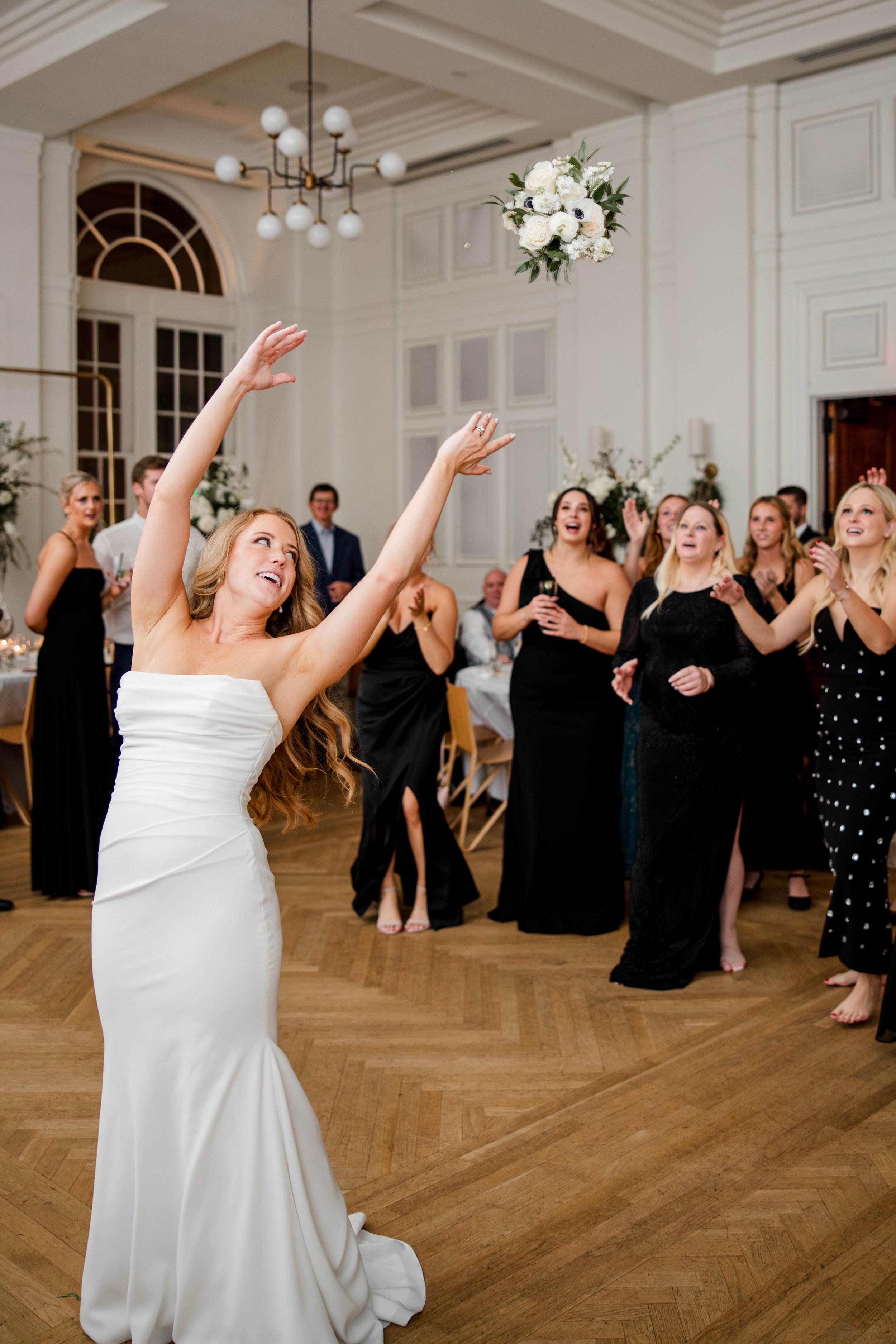 bride-tossing-bouquet-at-reception.jpg