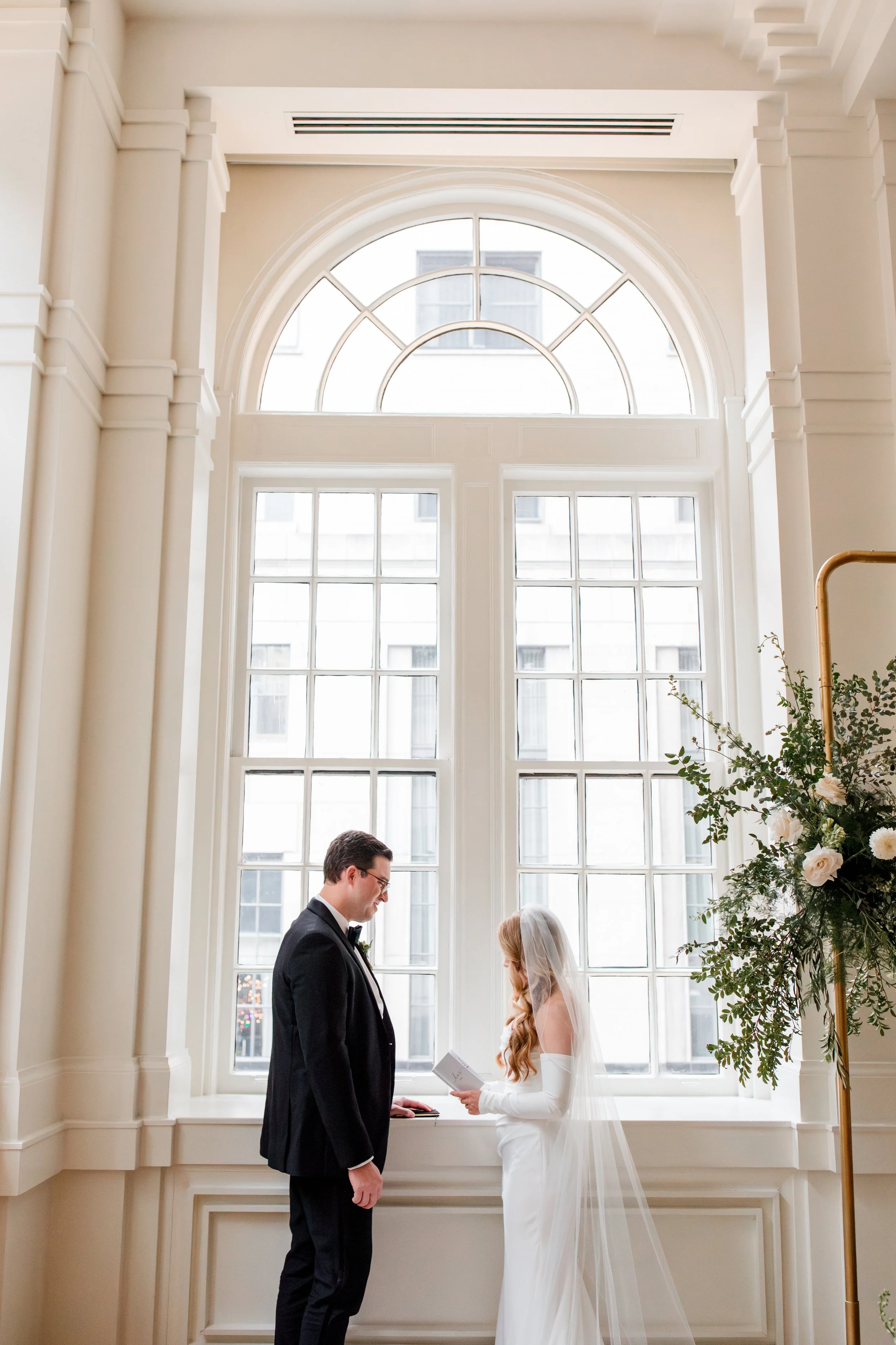 couple-sharing-vows-by-window.jpg