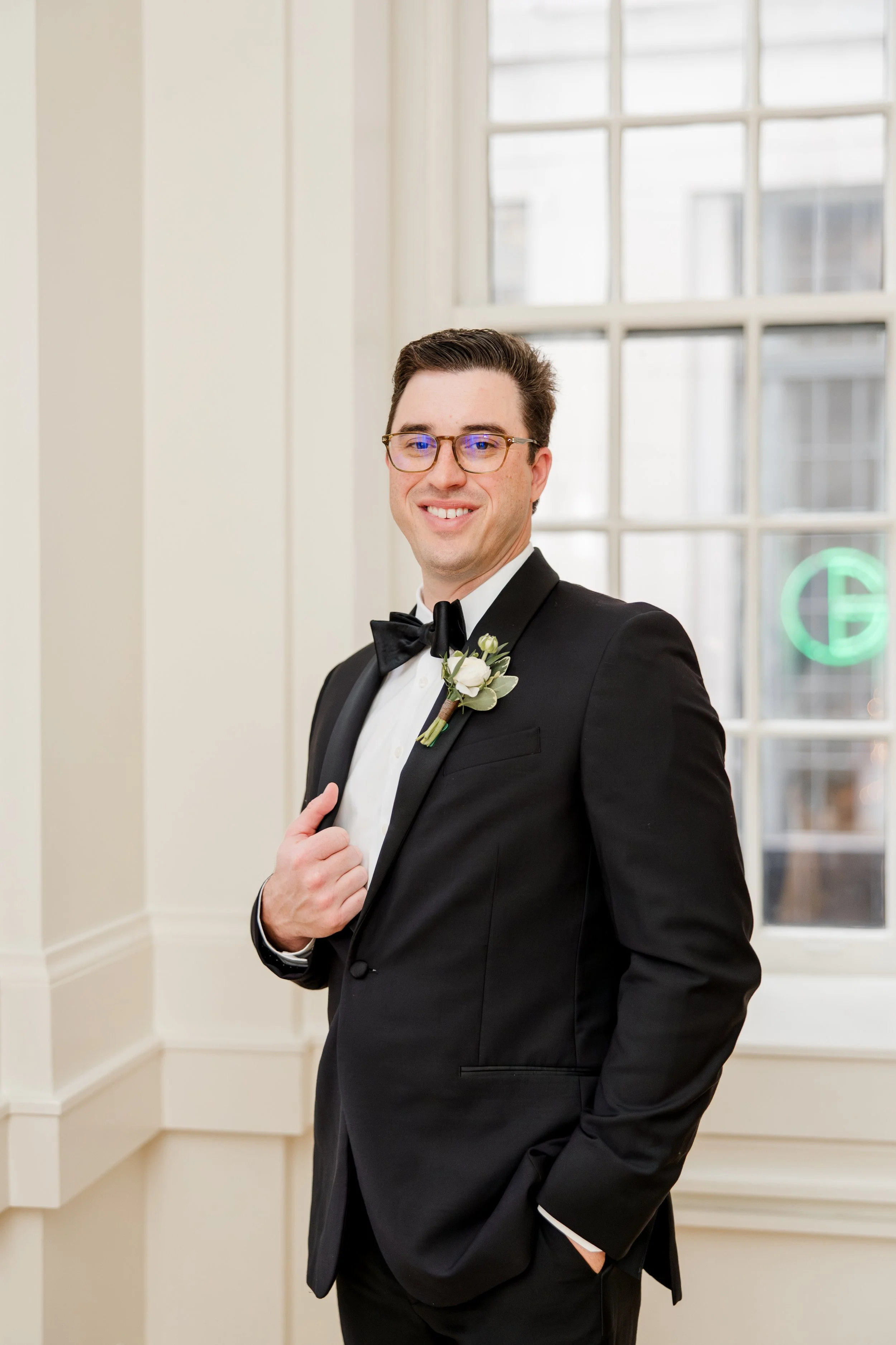 groom-grabbing-lapel-smiling.jpg