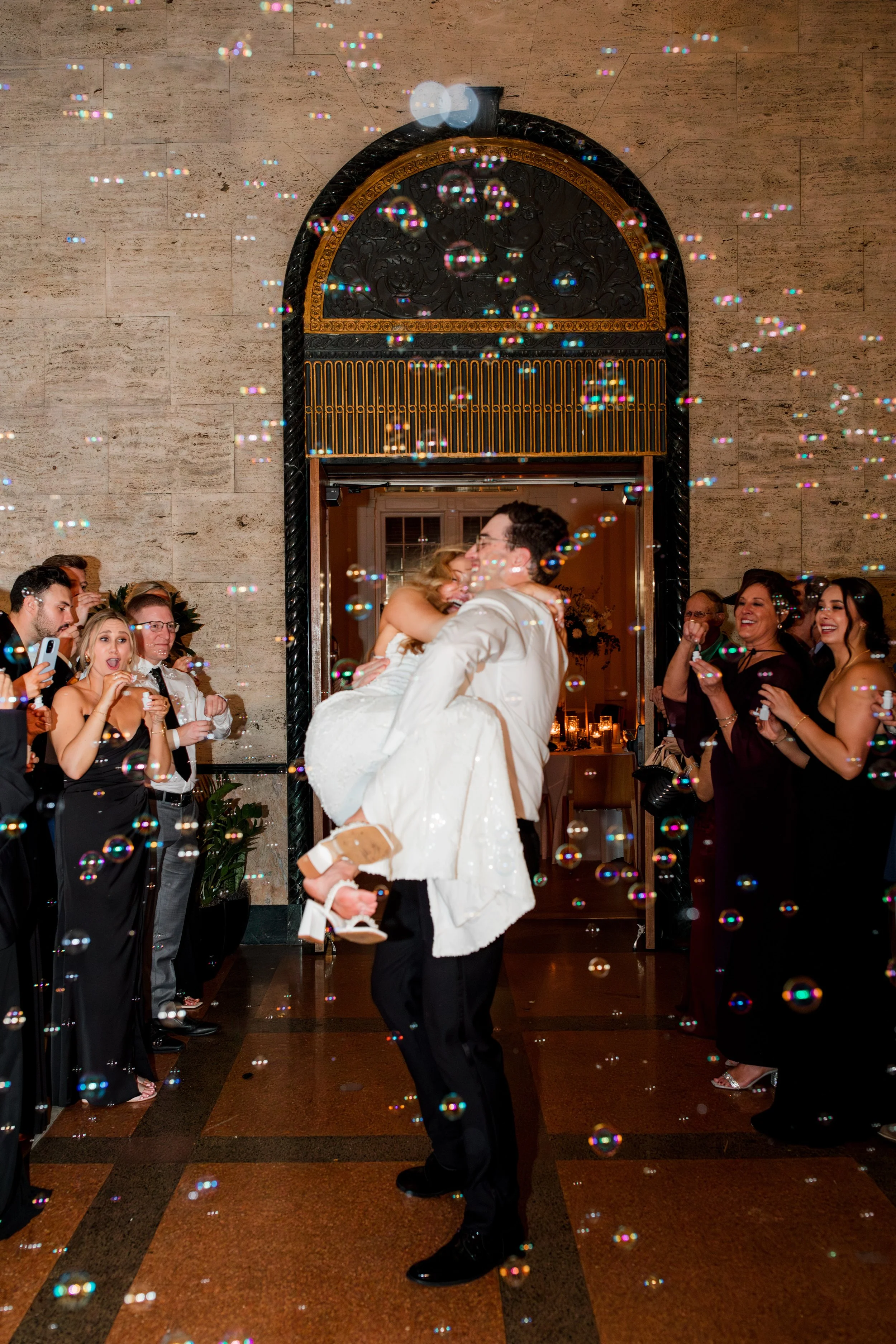 groom-lifts-bride-during-bubble-exit.jpg