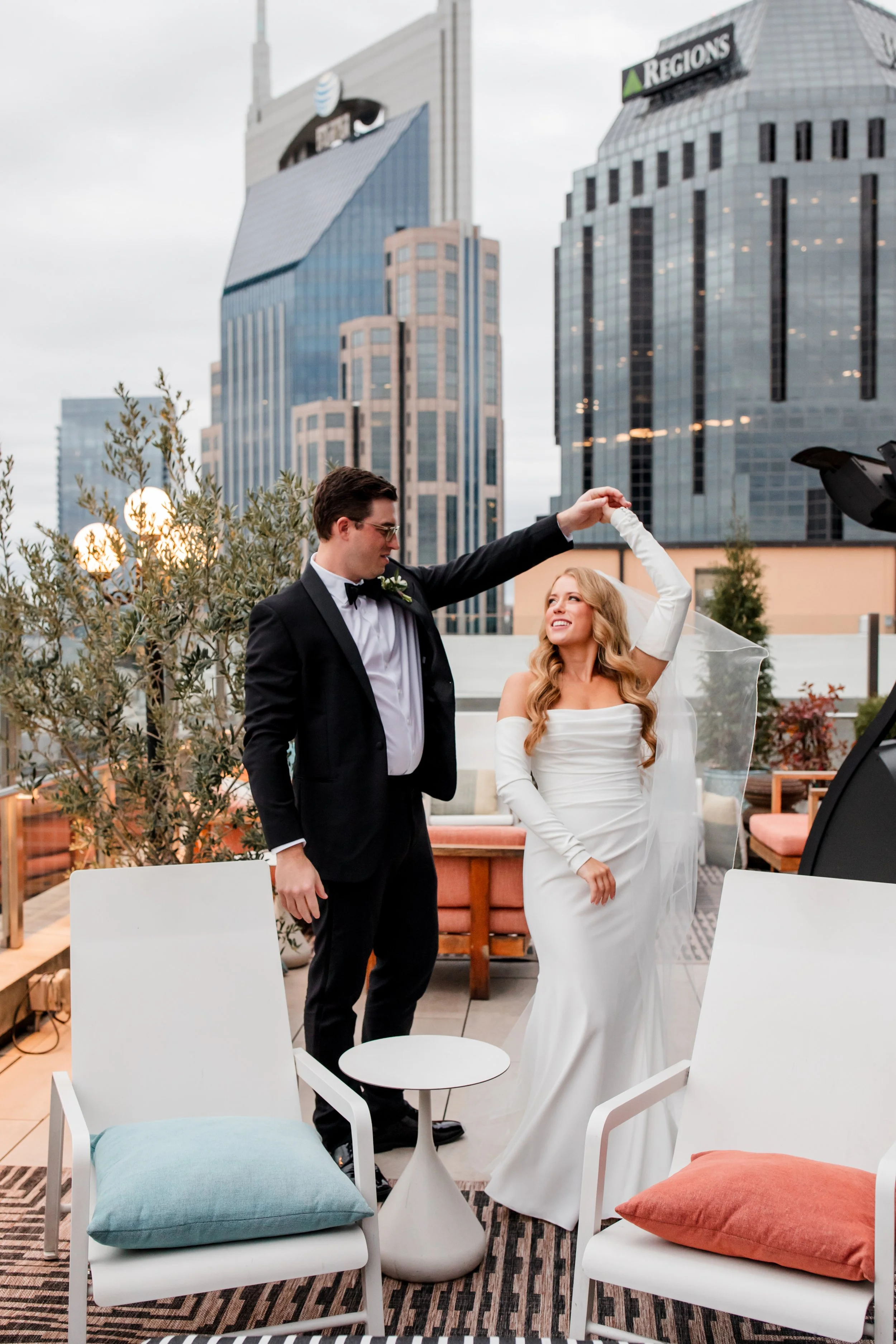 groom-twirling-bride-nashville-rooftop.jpg