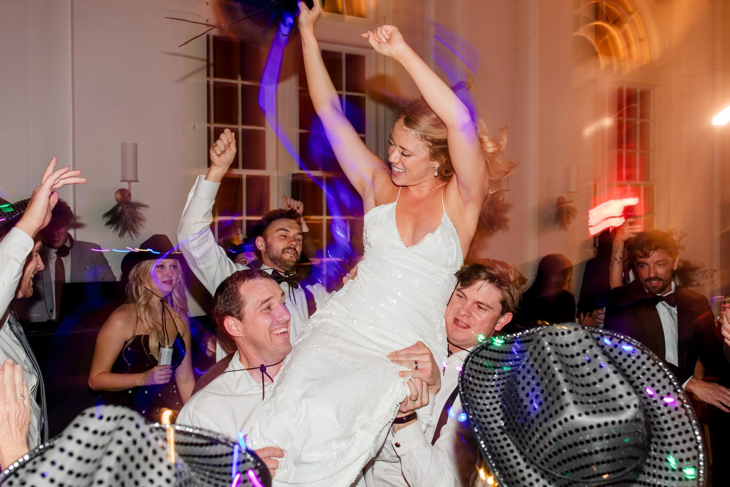 groomsmen-lifting-bride-during-reception.jpg