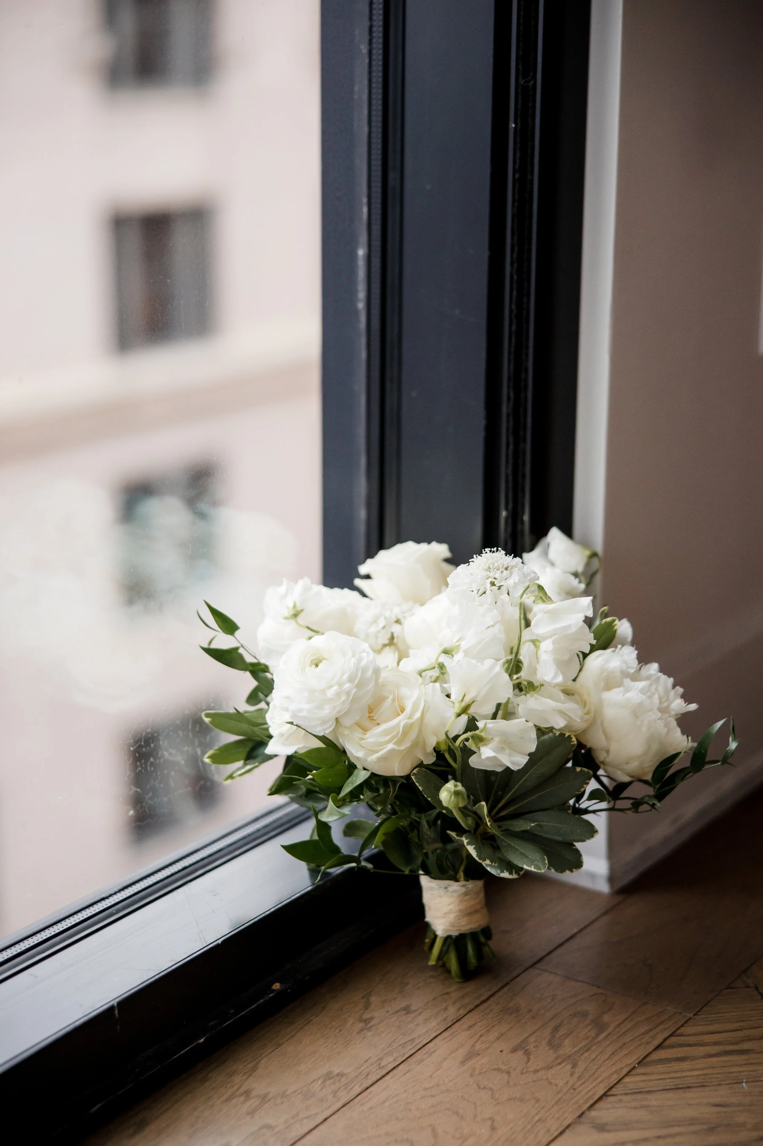 white bouquet-leaning-in-window.jpg