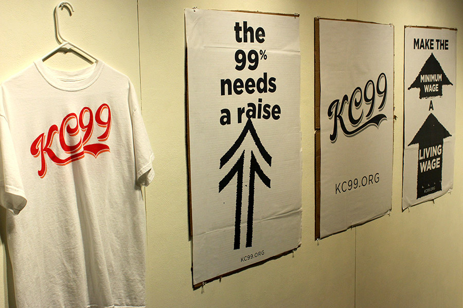  kc99 shirt and protest posters, in support of better pay for low-wage workers in k.c. 