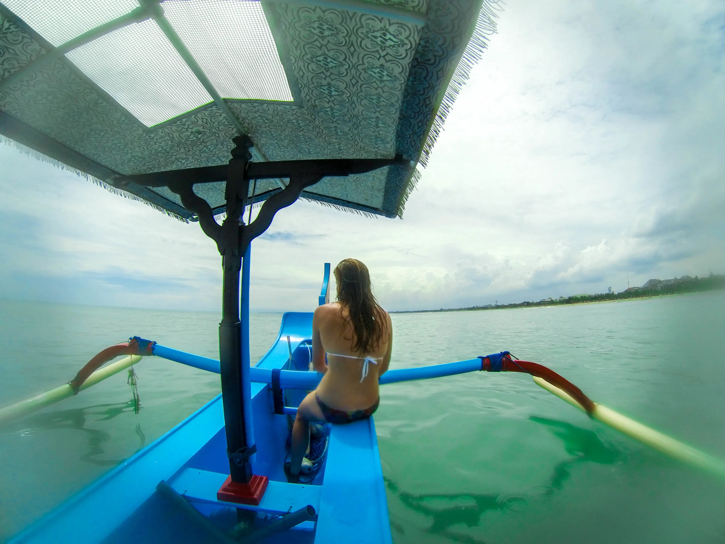 Taking a boat out to surf Airports, which is a reef break just near Kuta beach.