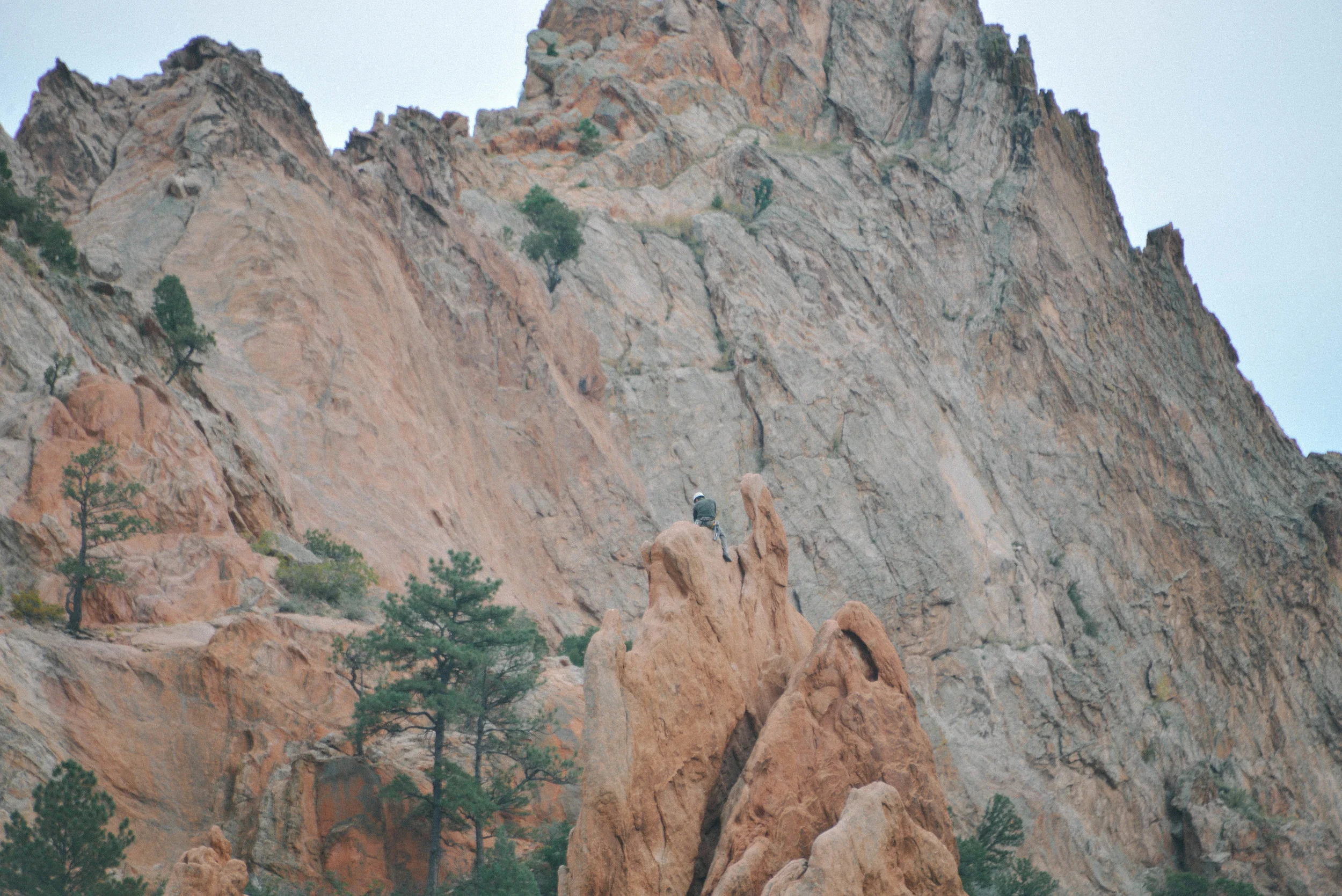 Rock climber sitting high.
