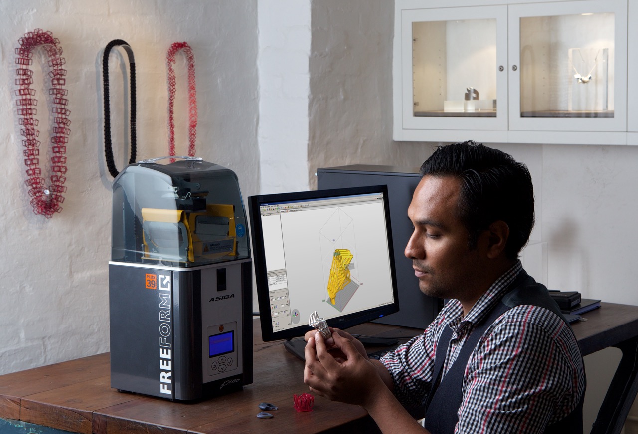 Cesar inspecting casting from a 3D printer borrowed to prototype new designs.