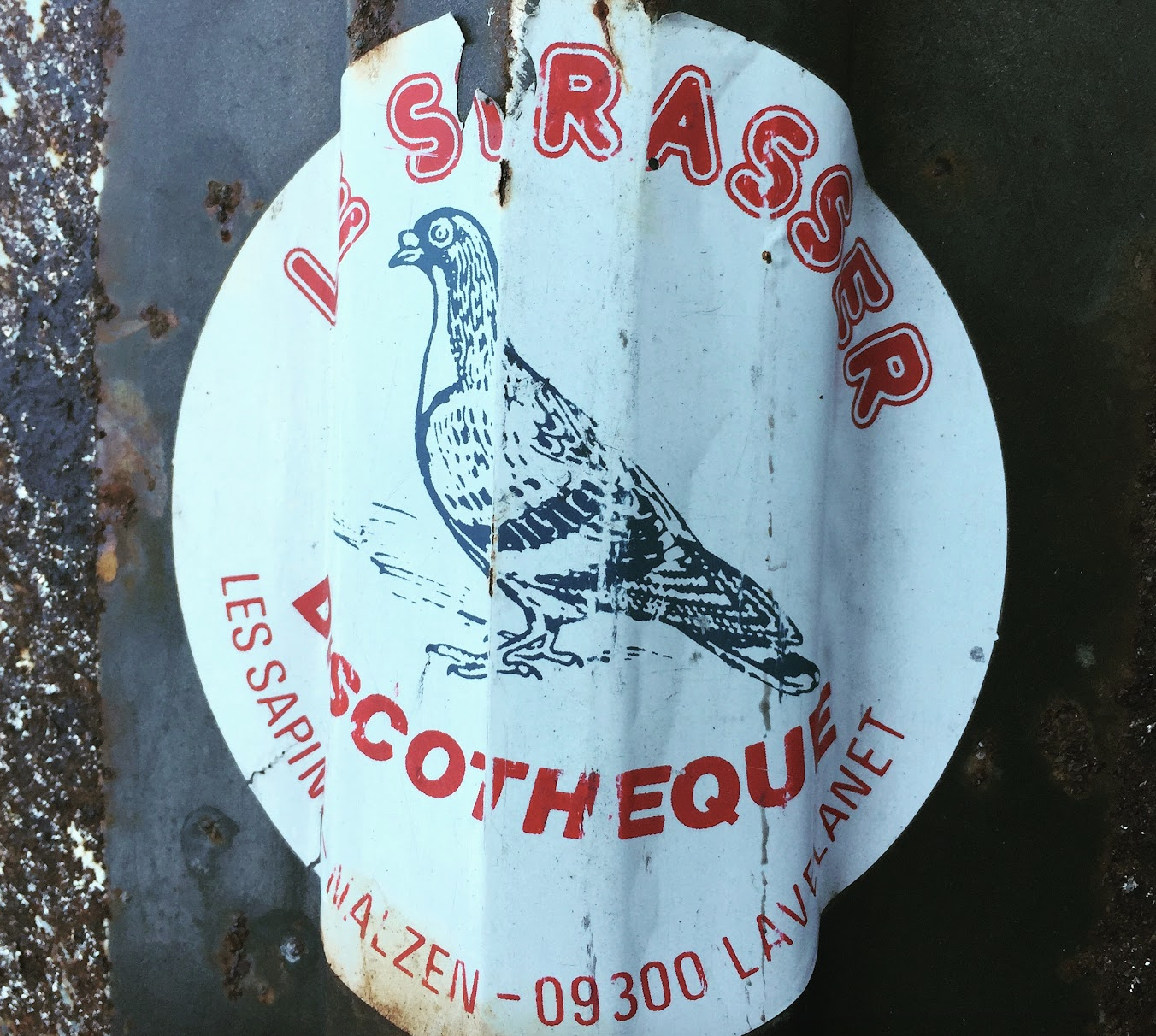 A weathered, torn sign with a picture of a turkey and the words "Turkey" and "Southwest" in red. The sign also includes the text "Les Sappin" and "09300 Lave | Ank" around the edges.