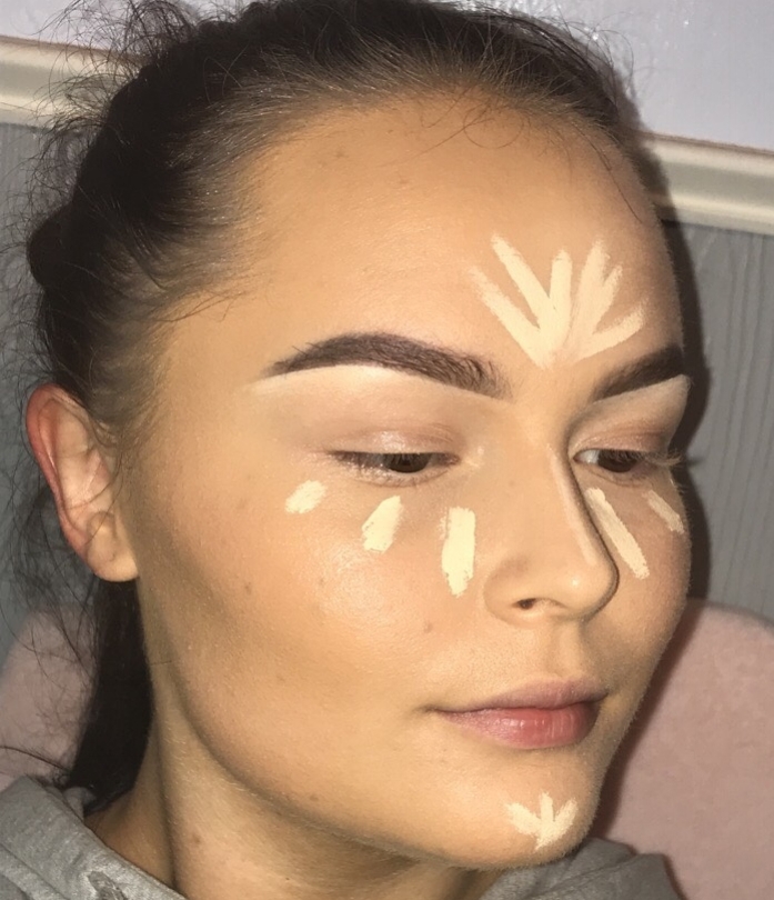 Highlight the center areas of the face with a shade about two shades more fair than your natural skin tone. Highlight can be applied on the under-eye area, bridge of the nose, chin, and forehead.