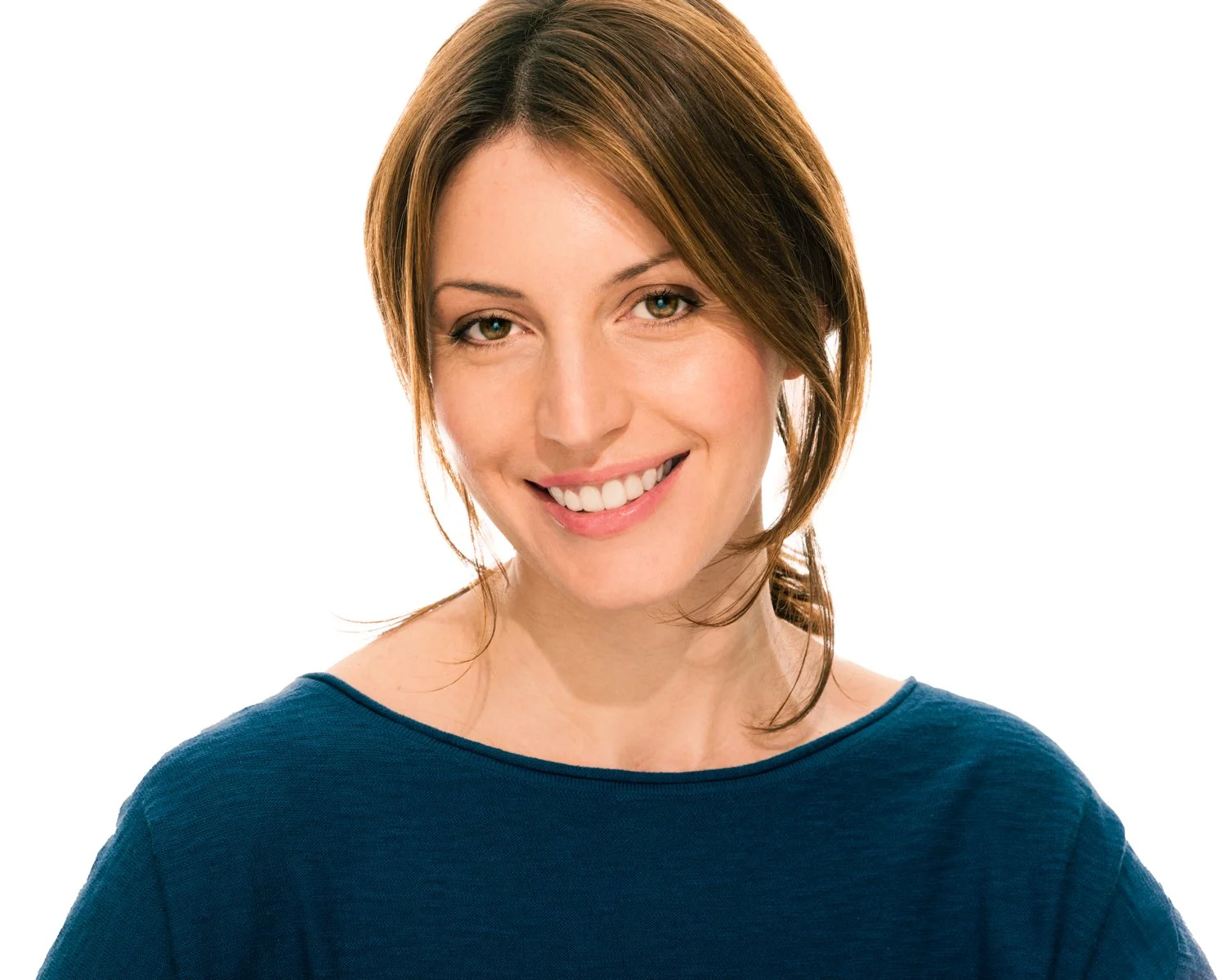 Portrait of a young woman with shoulder-length brown hair, smiling, wearing a blue top, against a white background.