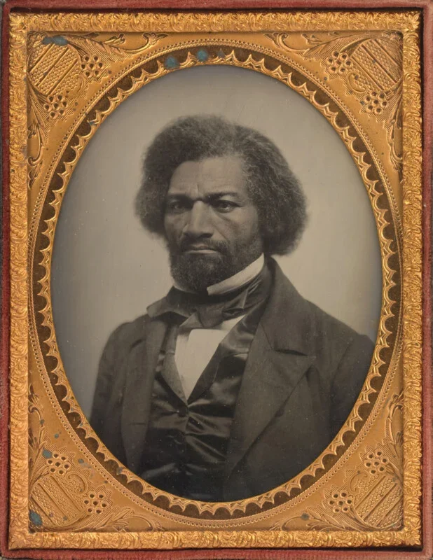 Portrait of abolitionist Frederick Douglass, circa 1856, framed by an ornate elliptical picture frame.