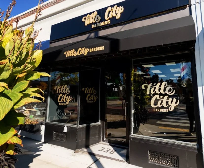 Exterior storefront of Title City Barbers.