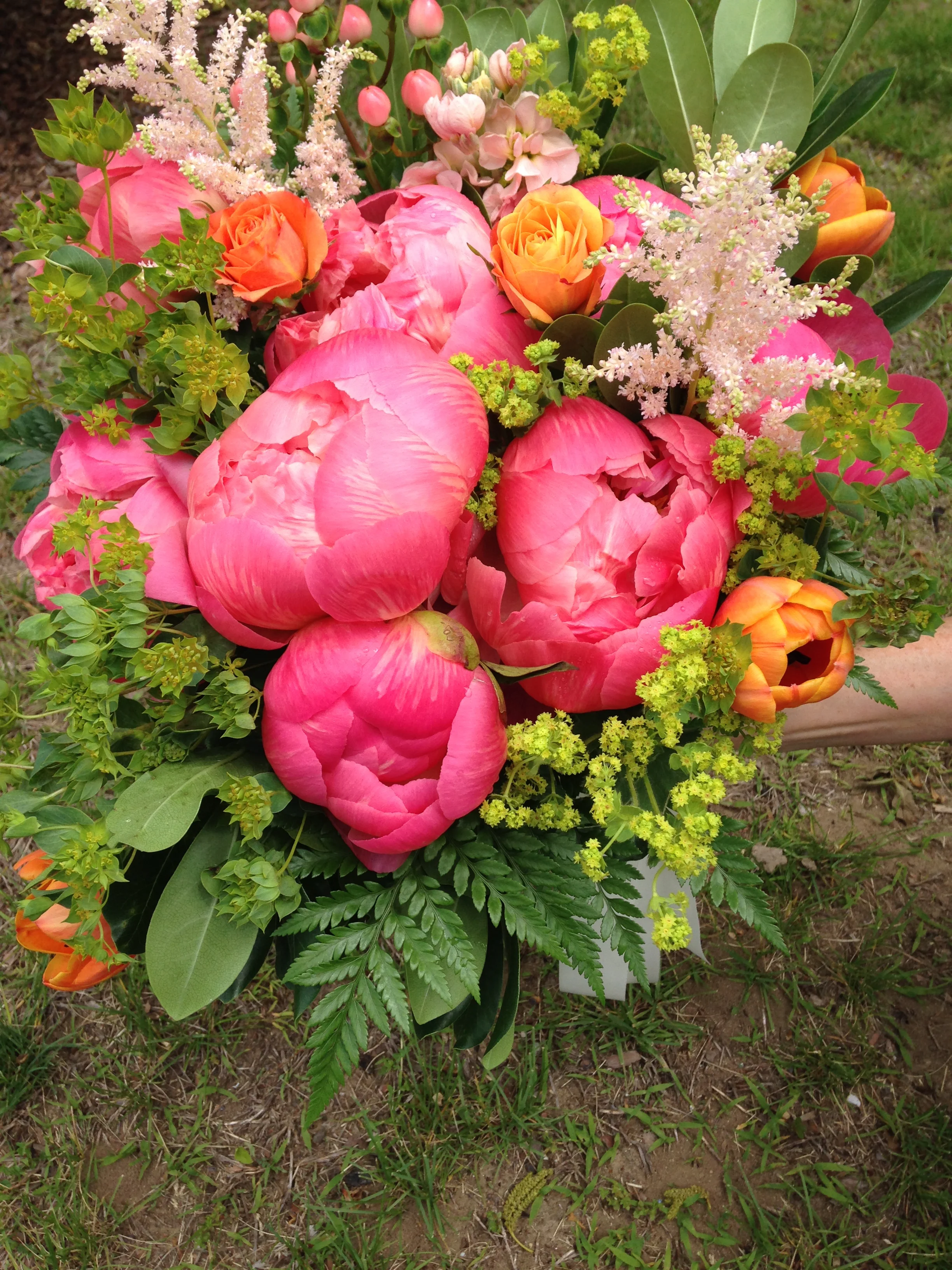 Coral peonies, vibrant tulips, and soft astilbe make a smashing bouquet.